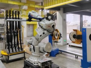 ABB robot holding automotive roof rails for cloth-wheel buffing