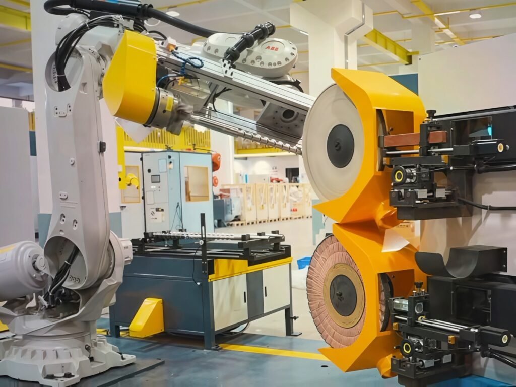 Robot handling an extruder screw beside stationary finishing wheels