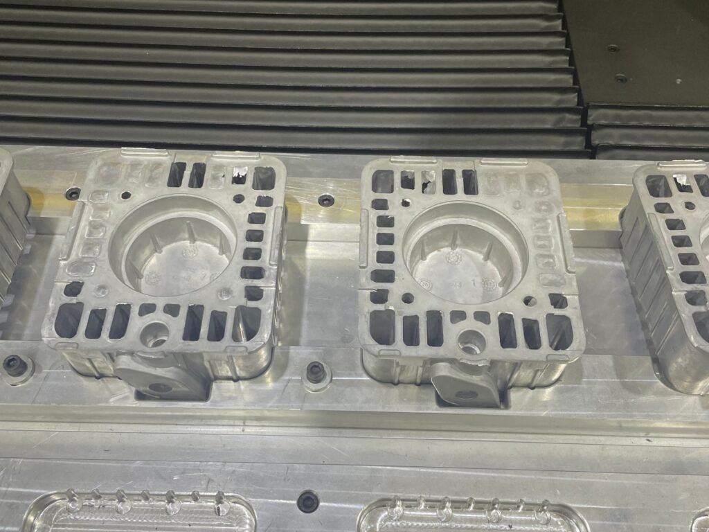 Cast metal parts with burrs before robotic grinding