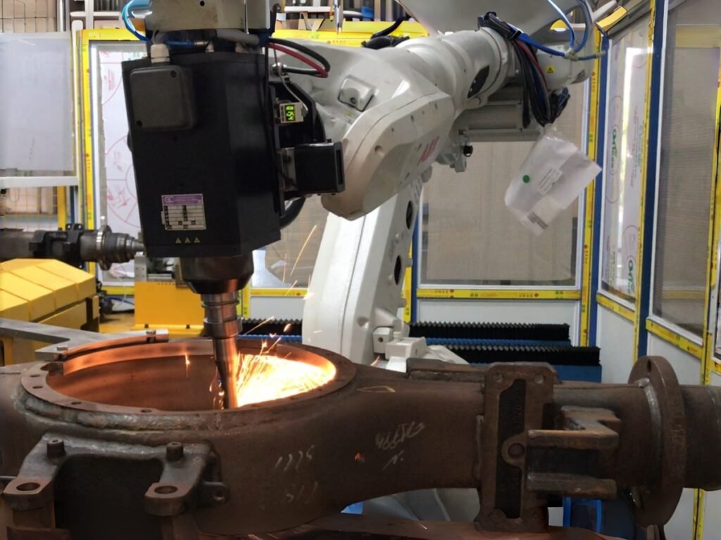Robot-mounted finishing tool processing a fixed metal workpiece